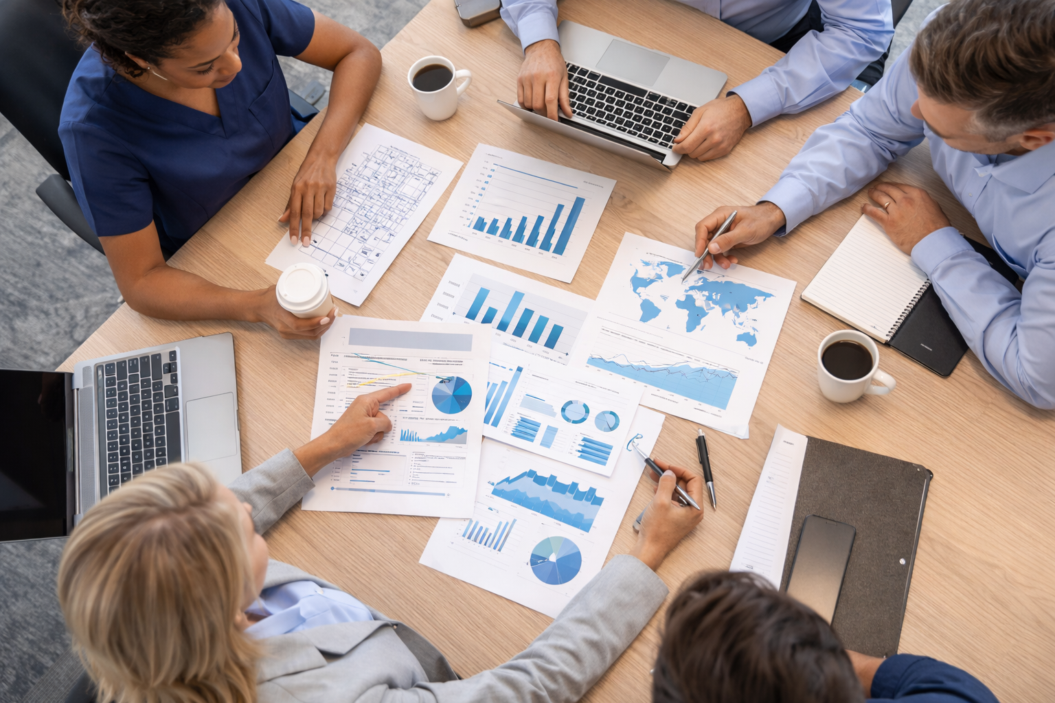 Healthcare leadership team reviewing strategy documents at a conference table
